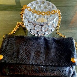 Authentic Henri Bendel blk clutch with gold removable chain. Measures 8 1/2”x 5”